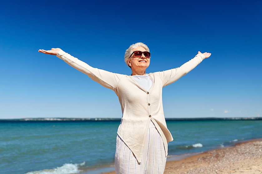 Portrait of senior woman in sunglasses on beach 