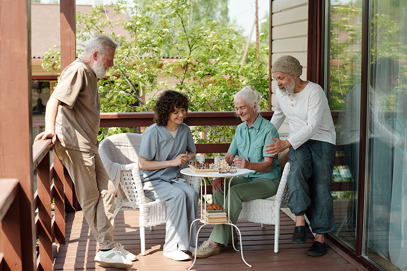 two-senior-men-beards-looking-aged-young-women-playing-chess